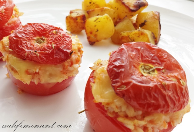 Stuffed Tomatoes with rice and cheese accompanied by roasted potatoes